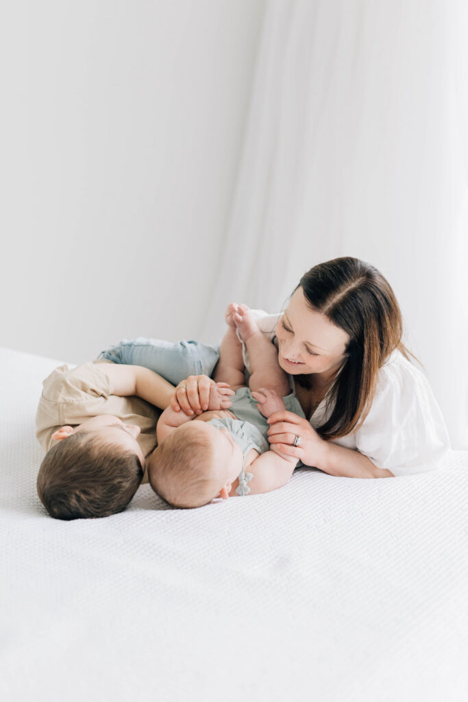 Photos I never want to live without: mother playing with her two young children during a cozy studio moment.