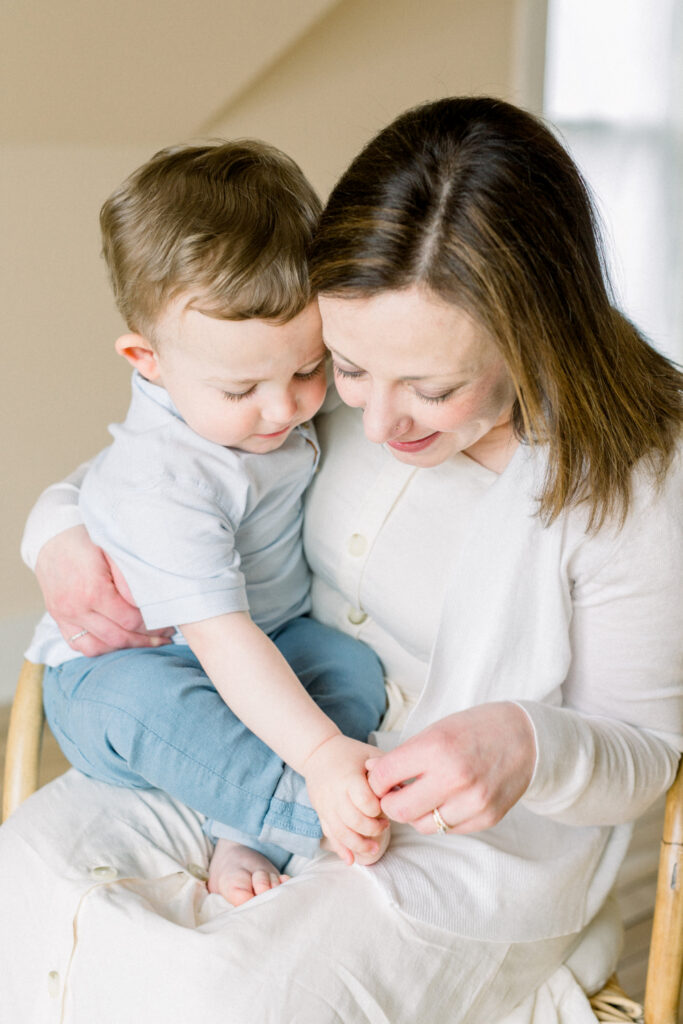 Photos I never want to live without: mother sitting with toddler, gently holding his feet during a quiet moment.
